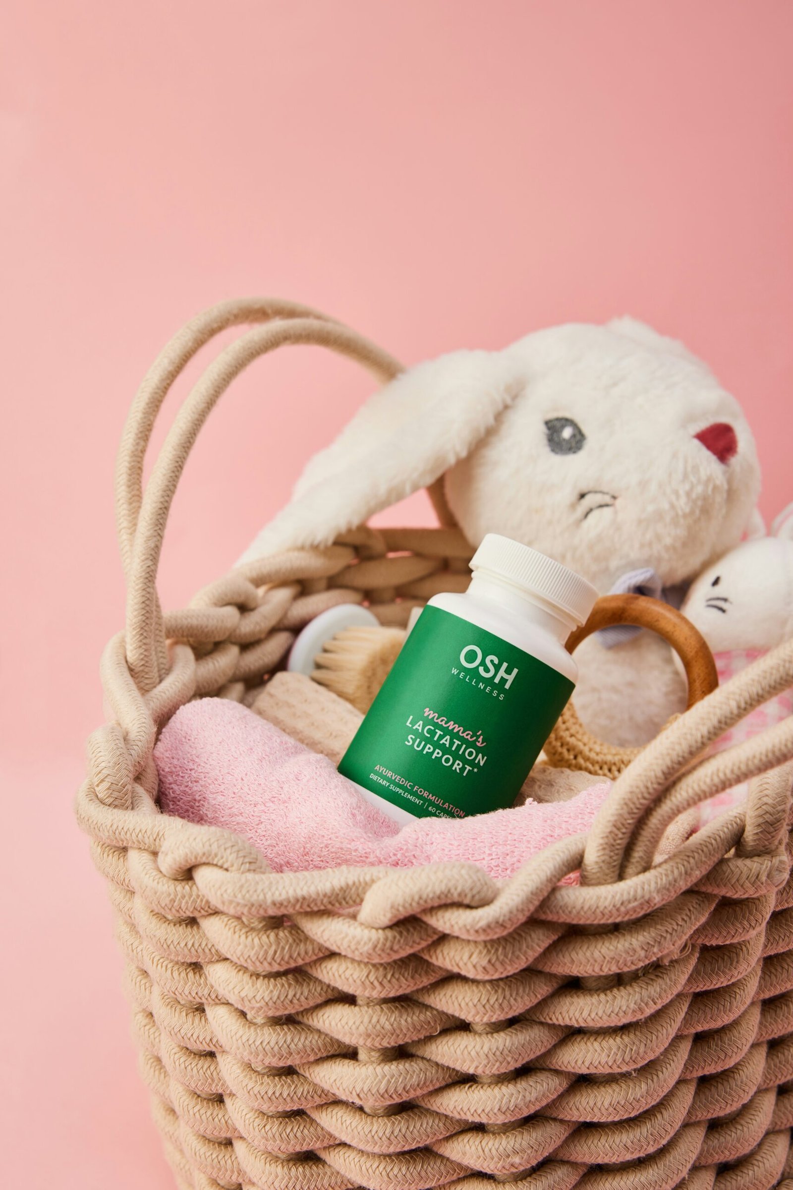 A basket filled with a stuffed animal and a bottle