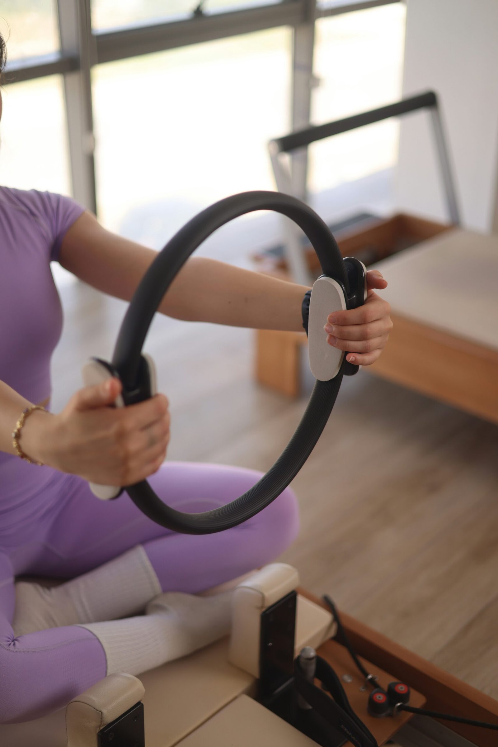 a woman sitting on the floor holding a steering wheel